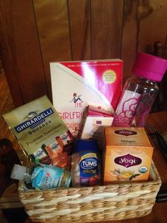 a basket filled with lots of different types of food and drinks on top of a table