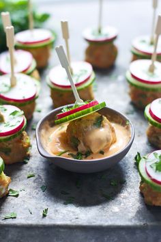 small appetizers with toothpicks and sauce in them on a table top