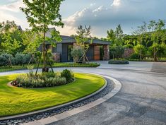 a circular driveway in front of a house with trees and bushes on the other side