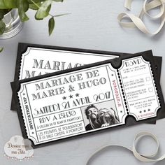 two black and white tickets sitting on top of a table