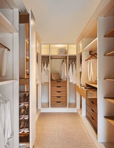 an empty walk in closet with lots of drawers