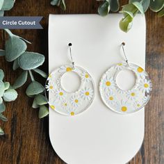 Step back in time and embrace the vintage vibe with our Daisy Patterned Earrings. These stunning earrings are made from high-quality clear acrylic and feature a fun and playful daisy pattern, reminiscent of the carefree era of the 70s. The intricate detailing and bold colors of the design make these earrings a showstopper, sure to add a touch of retro-chic to any outfit. Crafted with comfort in mind, these earrings are incredibly lightweight, making them ideal for everyday wear. The clear acryli Vintage Summer Hoop Earrings, Vintage Round Earrings For Summer, Adjustable Vintage Earrings For Summer, Summer Vintage Pierced Earrings, Vintage Dangle Earrings For Spring, Vintage Drop Earrings With Flower Charm, Vintage White Flower Drop Earrings, Vintage Yellow Earrings For Summer, Retro White Dangle Earrings