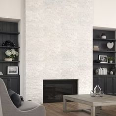 a living room filled with furniture and a fire place in front of a white brick wall