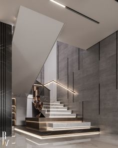 an elegant staircase with marble steps leading up to the second floor and lighting on either side