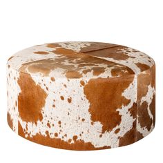 a brown and white cow print ottoman