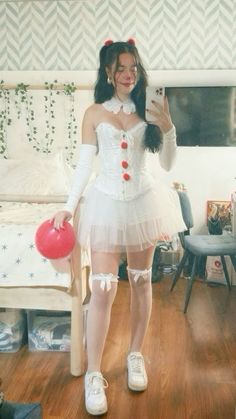 a woman in a white corset and red ballerinas is taking a selfie with her cell phone