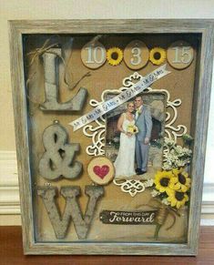 a wedding photo frame with sunflowers and the word love is in front of it