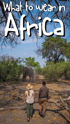 two people walking in front of an elephant with the words what to wear in africa