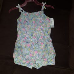 New With Tag Size 18 Months Carter's Floral Bodysuit. Blue Bubble Romper For Summer, Casual Blue Bubble Romper For Spring, Blue Summer Bubble Romper For Playtime, Summer Blue Sleeveless Bubble Romper, Blue Sleeveless Summer Bubble Romper, Spring Blue Bubble Romper For Playtime, Casual Pink Onesie For The Beach, Casual Blue Bubble Romper For Playwear, Blue Fitted Bubble Romper For Spring