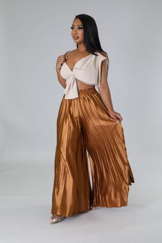 These high-waisted pants are for the fashion-forward woman who wants to make an elegant statement wherever she goes. Featuring a comfortable elastic waistband and pleated detail, these wide-legged beauties will take your wardrobe to the next level. Show off your chic style in these luxurious high-waisted pants. High waisted pants Elastic waistband Pleated Wide leg 30"Inseam No closure 97% Polyester 3% Spandex Hand wash cold Chic Wide-leg Culottes For Day Out, Chic High Waist Pleated Bottoms, Chic Wide Leg Pants For Day Out, Glamorous Summer Evening Wide Leg Pants, Glamorous Evening Wide Leg Pants For Summer, Glamorous Wide Leg Pants For Summer Evenings, Chic Wide Leg Pants With Elastic Waistband, Versatile High-waisted Wide Leg Pants For Day Out, Chic Straight Pants With Pleated Waist