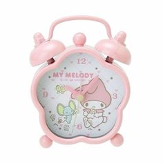 a pink alarm clock with hello kitty on the face and numbers, says my melody