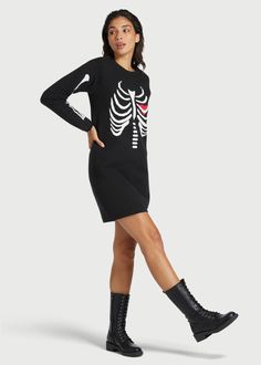 A chilling reminder of what lies beneath, this spooky-yet-sweet sweater dress from our ModCloth namesake label is just is time for Halloween and cute enough for year-round wear. Made from a soft cotton knit, this black sweater dress boasts an intarsia knit, white skeletal rib cage atop a vibrant red heart at the chest, skeletal arm bones down the long sleeves, and ribbed-knit detailing at the crew neckline, cuffs, and hem. Featuring a relaxed-fit that finishes above the knee and is perfect for cool-weather layering, this retro-inspired sweater dress is so much fun to style ! 50% Viscose, 28% Polyester, 22% Polyamide Imported Model Measurements: Height: 5'8"/173cm Bust: 34/86cm Waist: 25 1/2"/65cm Hip: 36"/91cm Dress: 2 US / 6 AU / XS | ModCloth The Love Remains Sweater Dress in Black Fall Black Dress With Graphic Print, Black Long Sleeve Emo Dress, 60s Mod Fashion, Arm Bones, Statement Outfit, 70s Outfits, What Lies Beneath, Black Sweater Dress, 1970s Fashion