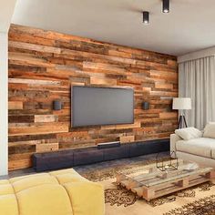 a living room with wood paneling on the wall and a flat screen tv mounted to the wall