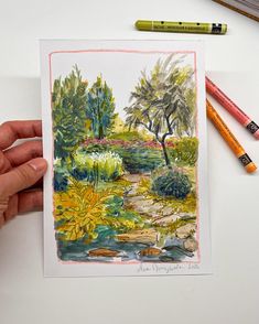 a drawing of a garden with flowers and trees in the background, surrounded by crayon pencils