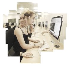 two women sitting in front of a computer monitor with their hands on the keyboard and mouse