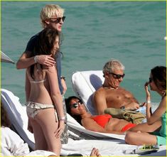 two women and one man are on the beach