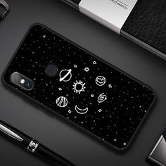 an image of a phone case with planets and stars in the sky on black background