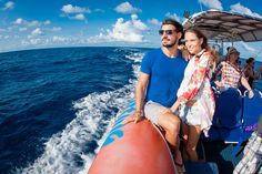 a man and woman on a boat in the ocean