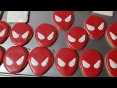 red and white decorated cookies sitting on top of a cookie sheet