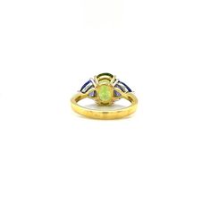 The sophisticated color pairing of green peridot and rich tanzanites in this elegant ring is absolutely mesmerizing! We have combined a gorgeous 3.62 carat brilliant peridot oval with two sparkling trilliant-cut tanzanites in this updated version of a classic three-stone ring. The vibrant "Granny Smith" green peridot looks stunning perched between the unmistakable purple-blue color of the tanzanites. A rich statement of everyday elegance and creative style, this ring is perfect for both daytime and evening wear. Handmade in 18k white and yellow gold by our Master Jewelers in Los Angeles. This ring will always be in style and would make a beautiful addition to any fine jewelry wardrobe! Size 6.5Complimentary sizing as neededPeridot, 3.62 caratsTanzanites 1.36 carats Green Three Stone Peridot Jewelry, Green Peridot Rings With Round Stone, Round Peridot Gemstones With Accent Stones, Luxury Multi-stone Peridot Ring, Luxury Peridot Three-stone Rings, Color Pairing, Ring Pendant Necklace, Green Peridot, Elegant Ring