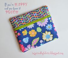 a colorful flowered pouch with the words if you're happy and you have it pouch