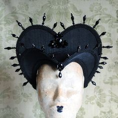 The Queen of Darkness headdress is a glorious Tudor inspired attifet headdress with a gothic twist!This vampire style headdress is covered with black silk shantung and embellished with black cord trimming all around the edges.It is further trimmed with black crystal details that create a halo effect. The piece is completed with a black crystal handmade elements placed at the center of both at the frond as well as the back part,to add that extra drama that we all love! The base is a headband styl Vampire Headpiece, Black Vampire, Alice In Wonderland Dress, Festival Headpiece, Heart Costume, Queen Of Hearts Costume, Dark Queen, Headband Styles, Costume Hats