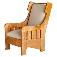 a wooden chair with beige upholstered cushions