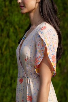 a woman with long hair wearing a floral dress