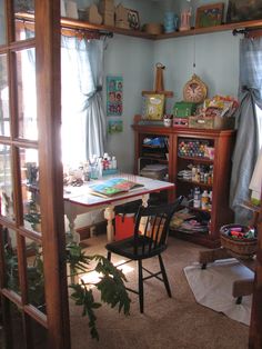 the room is very cluttered with things to do in it, including books and toys