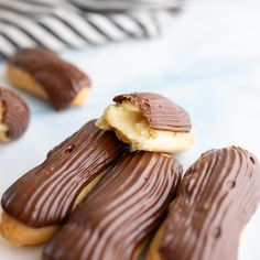 chocolate covered cookies with white frosting on a table