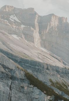 two people standing on the side of a mountain