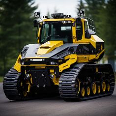 a yellow and black bulldozer is parked on the street in front of some trees