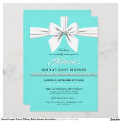 a blue and white baby shower card with a bow on the front, and pearls in the back