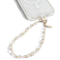 a cell phone with a chain attached to it's back case that has a cross on it