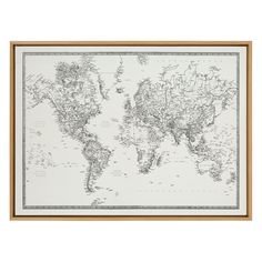 a framed world map with the countries in black and white, hanging on a wall