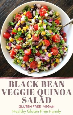 black bean veggie quinoa salad is shown in a white bowl on a wooden table