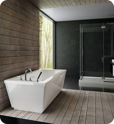 a large white bath tub sitting on top of a wooden floor next to a walk in shower