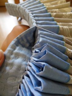 a person is holding something in front of the baby's diaper that has been folded over