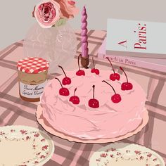 a pink cake with cherries on it sitting on a table next to other plates