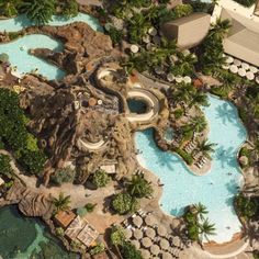 an aerial view of a water park with slides and pools in the middle of it