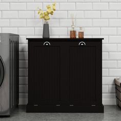 a black cabinet next to a washer and dryer