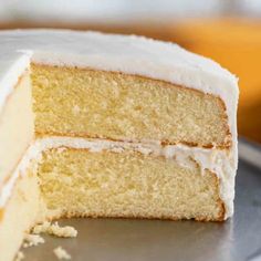 a cake with white frosting sitting on top of a plate