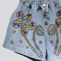 Uncover the perfect balance of classic vibe and modern charm with our 2023 Summer Collection's flower ornament embellished denim shorts. With a high-waist. free silhouette. these y2k inspired shorts are accented with buttons and rubber closure for a secure fit. Make a statement in these versatile shorts and step into the season with timeless style and effortless grace!Distinctive Features: Y2K-Style: An ode to the past. fashionably reimagined with a modern twist. High-Waist: Captivatingly cinche Y2k Style Jean Shorts For Summer, Y2k Jean Shorts For Summer, Summer Y2k Jean Shorts, Y2k High-waisted Shorts, Y2k Style Denim Blue Jean Shorts For Summer, Y2k Denim Blue Jean Shorts For Summer, Y2k Style Short Jean Shorts For Summer, Trendy Short Jeans For Festivals, Trendy Short Length Festival Jeans