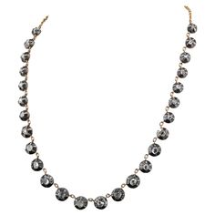 This outstanding Georgian Style necklace has been hand crafted of solid 18 KT gold and silver A full line of Rose cut Diamonds set in the Georgian manner graduated in size from bigger standing in the middle point chasing down in sizes There are 26 Rose cut Diamonds of fine quality calculated 6.0 Ct of Diamonds in total Necklace weighs 25.3 grams It is of timeless beauty wearable at any occasion displaying the Georgian elegance and discrete charm of the unique pieces of jewellery Excellent condition Metal: 18 Kt rose gold and silver, tested Hallmarks: none/worn Gems: 26 rose cut diamonds totalling 6.00 Ct Measures: total length (open) is 38 cm. – largest setting is 8 mm. in diameter Weight: 25.3 grams Condition: very good keeping with age Riviere Necklace, Rose Gold And Silver, Style Necklace, Rose Cut Diamond, Link Necklace, Gold And Silver, Rose Cut, Timeless Beauty, Or Rose