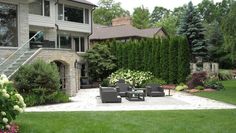 an outdoor living area with furniture and landscaping