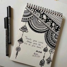 a notebook with a quote on it next to a pen