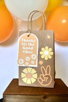 a brown paper bag with an orange and white balloon in the background