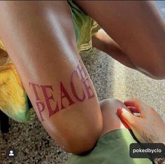 a person with tattoos on their legs that say peace