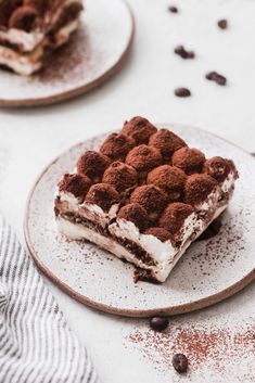 two plates with desserts on them sitting on a table