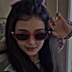 a woman with long hair and cat ears on top of her head wearing pink sunglasses